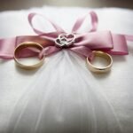 Two rings are tied in a lace, a decorated wedding gift.