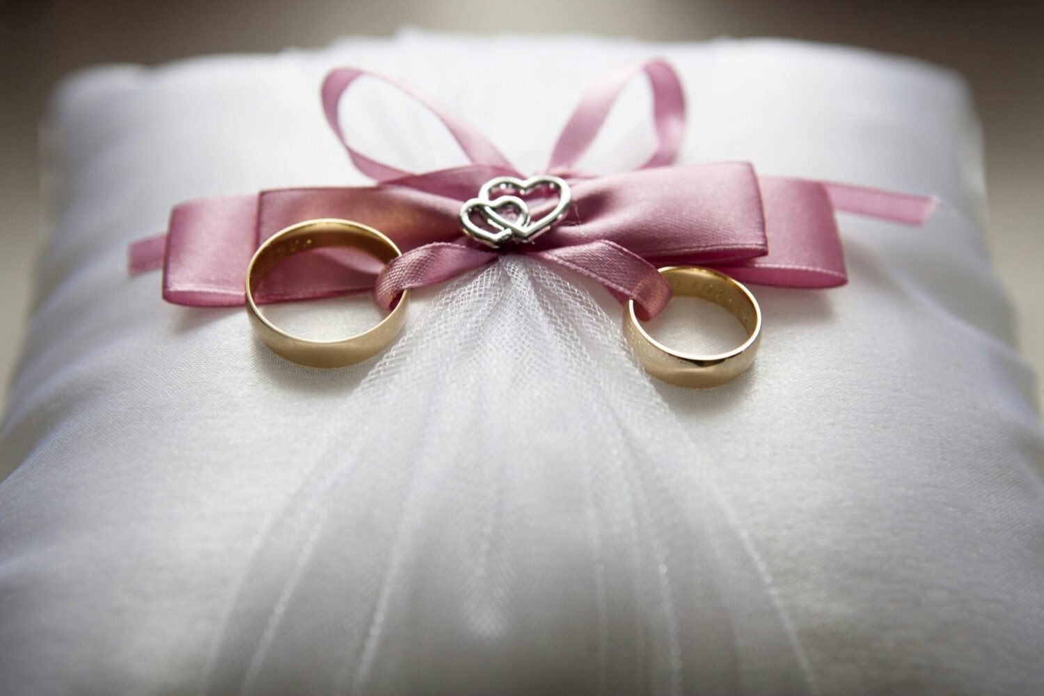 Two rings are tied in a lace, a decorated wedding gift.