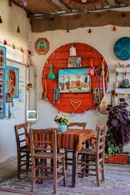 A beautiful house corner. Decorated with colorful handcrafted home decor and at center a table with four chairs.