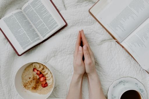 A morning routine with journaling, healthy breakfast, coffee mug and a book on the table.